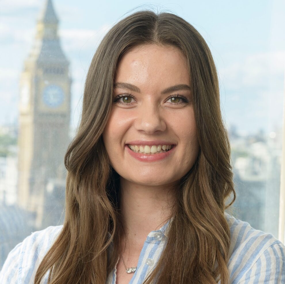 Woman with long brown hair smiling for professional headshot