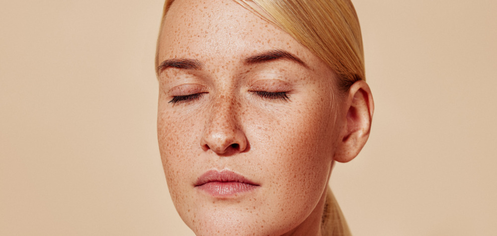 Close up image of a woman with her eyes closed, looking relaxed