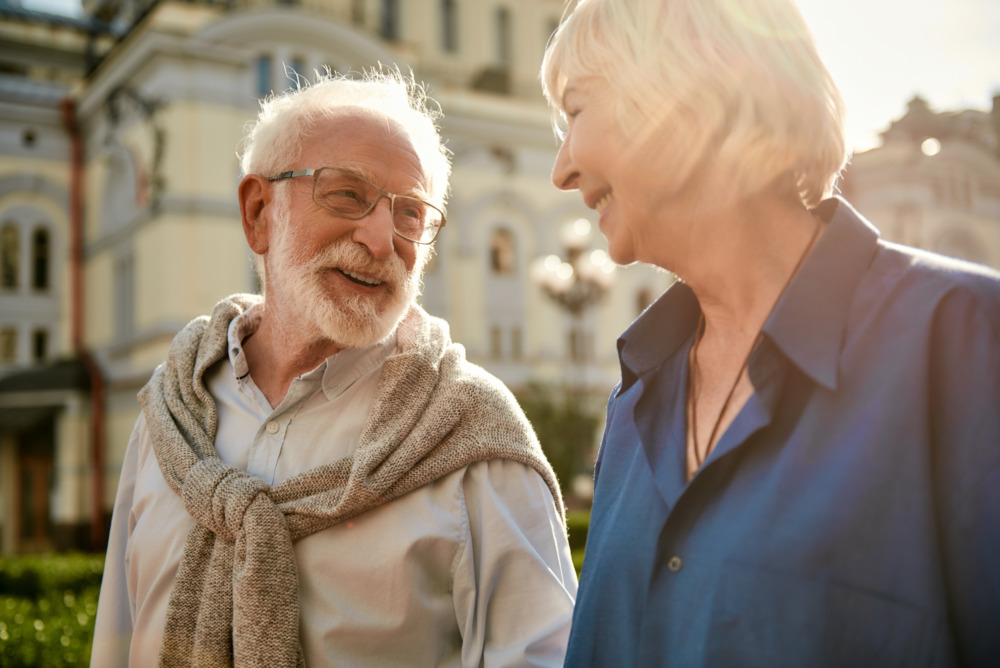 You are making me happy. Beautiful elderly couple looking at each other and smiling while spending time together outdoors. Family. Love concept